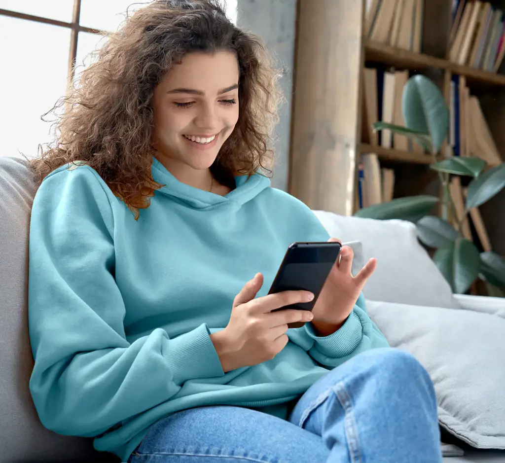 woman using AT&T phone and signing up for AT&T Protect Advantage for 1